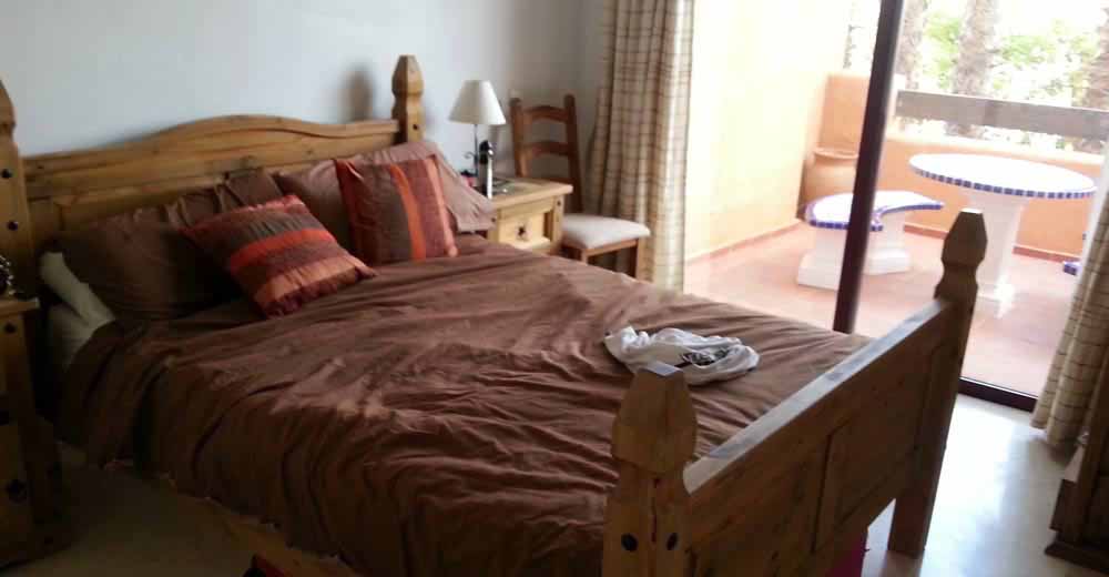 masterbedroom with en-suite in the villamartin apartment, leading out to the blacony